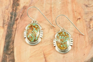 Beautiful High Grade Genuine Number 8 Mine Spider Web Turquoise Stones set in Sterling Silver French Wire Earrings. The Number 8 mine is located in Eureka County Nevada. Since 1976 there has been no Number 8 Turquoise mined. There is however, an existing stock pile that Mr. Dowell Ward, the last owner of the Number 8 mine, had stocked away for later sorting. The Turquoise is a collector's item--because once the reserve is gone there will be no more material released onto the market. The Gold Mining Company owns the claim to the Number 8 mine and it has been swallowed up by the gold mining operations. This is some of the last Number 8 Turquoise to be had and will be a great addition to your collection. Created by Navajo Artist Bobbie Piaso. Signed by the artist. 
